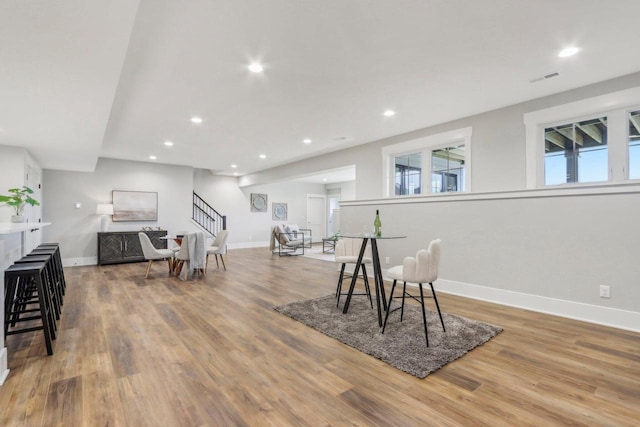 dining space featuring stairs, recessed lighting, wood finished floors, and visible vents