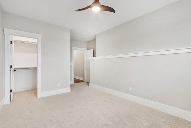 unfurnished bedroom featuring a closet, baseboards, carpet, and ceiling fan