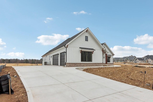 exterior space with brick siding and concrete driveway