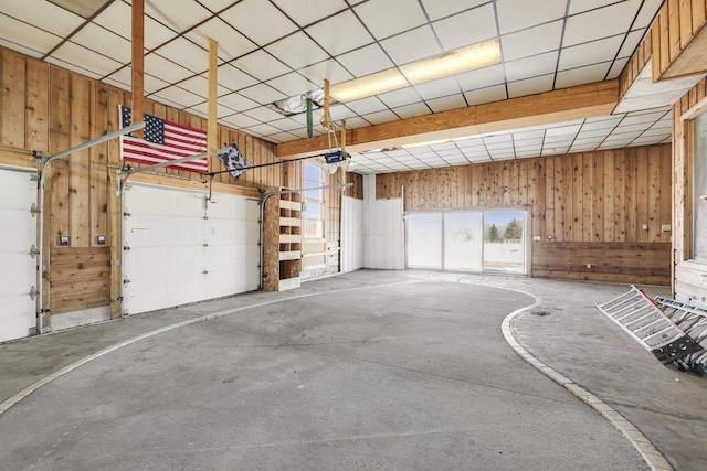 garage with wooden walls and a garage door opener