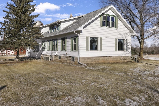 view of home's exterior featuring cooling unit and roof with shingles