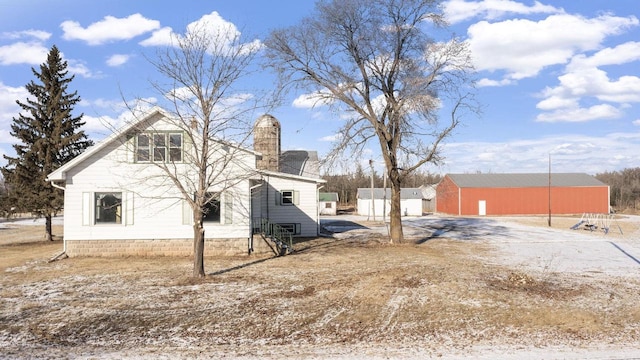 exterior space featuring an outbuilding and dirt driveway