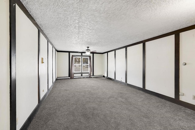 spare room featuring carpet, ceiling fan, and a textured ceiling