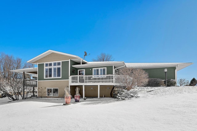 snow covered house with a carport