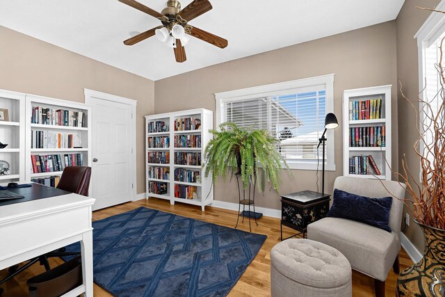 home office with plenty of natural light, ceiling fan, baseboards, and wood finished floors