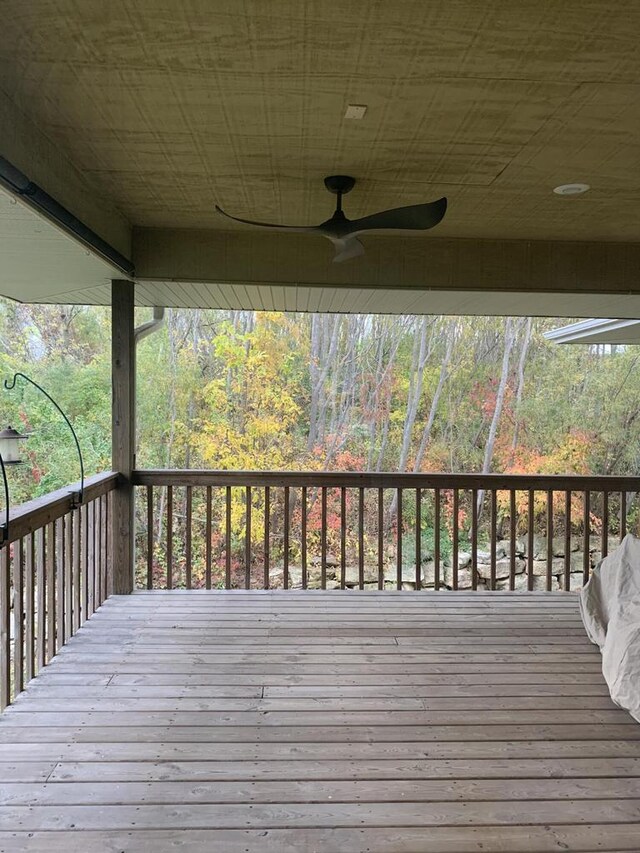 wooden terrace with a wooded view