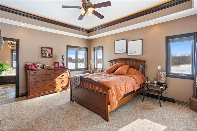 9073 Richfield Dr, Marshfield, WI 54449 - carpeted bedroom featuring a tray ceiling, baseboards, ornamental molding, and a ceiling fan