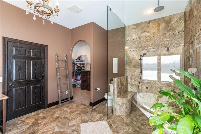 9073 Richfield Dr, Marshfield, WI 54449 - full bathroom with visible vents, a tile shower, a walk in closet, toilet, and a bathtub