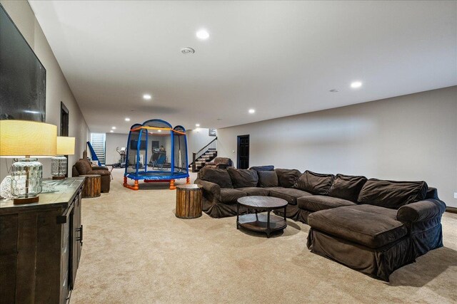 9073 Richfield Dr, Marshfield, WI 54449 - living room with recessed lighting, light colored carpet, and stairs