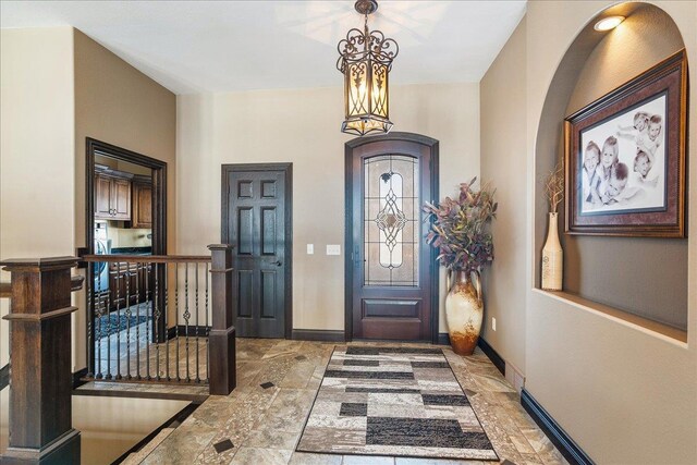 9073 Richfield Dr, Marshfield, WI 54449 - foyer featuring an inviting chandelier and baseboards