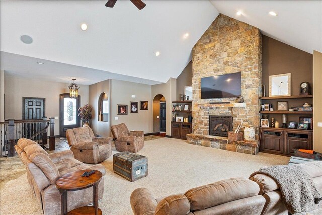 9073 Richfield Dr, Marshfield, WI 54449 - living room with built in shelves, arched walkways, carpet, a stone fireplace, and ceiling fan
