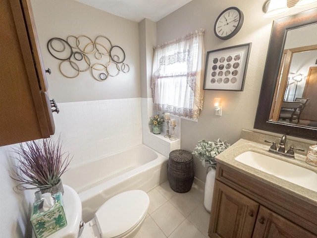 bathroom with tile patterned flooring, vanity, toilet, and a bath