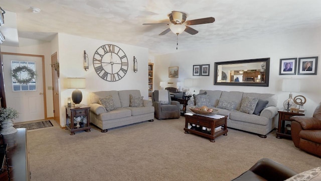 carpeted living area with ceiling fan