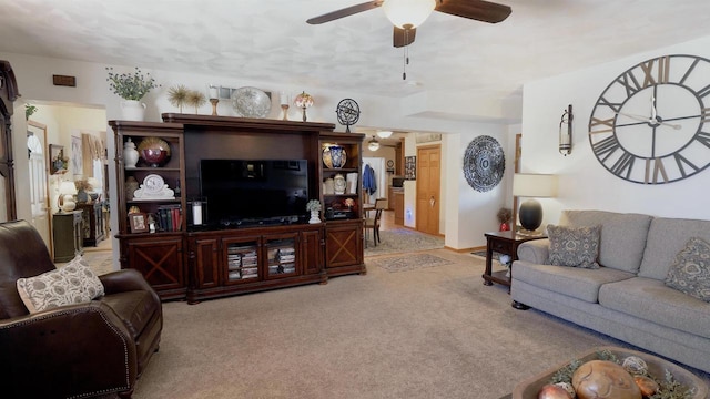 living room featuring light carpet and ceiling fan