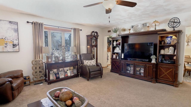 living room featuring carpet and ceiling fan