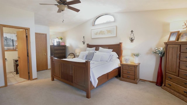 bedroom with light carpet, ensuite bathroom, ceiling fan, and vaulted ceiling