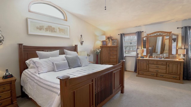 bedroom featuring vaulted ceiling and light colored carpet