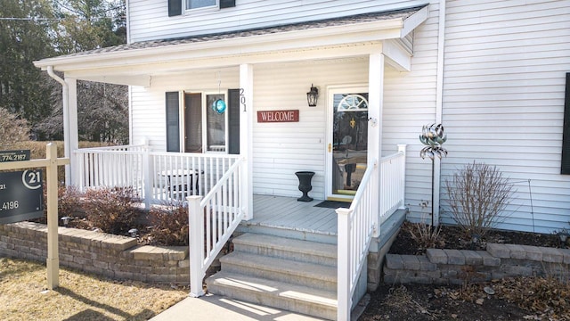 view of exterior entry with a porch