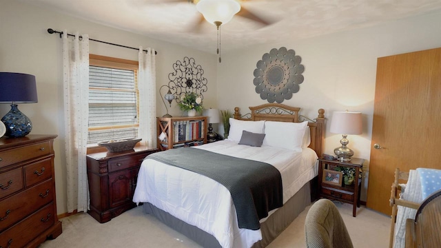 bedroom featuring light carpet and ceiling fan