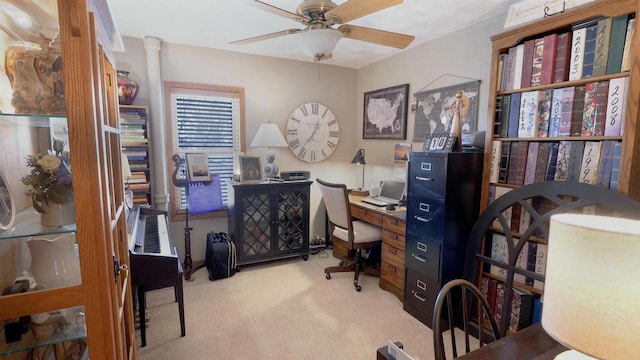 carpeted office space with a ceiling fan