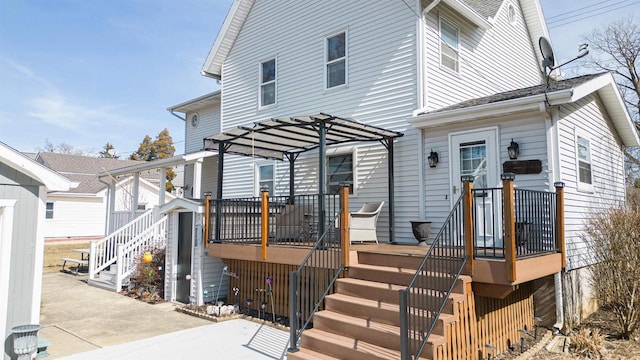 view of front of house featuring stairs, a pergola, and a wooden deck