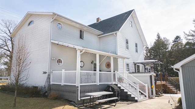 view of front of house featuring stairway and a chimney