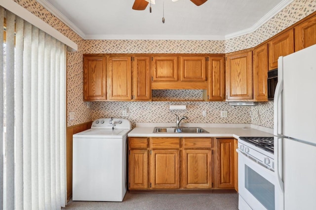 interior space with wallpapered walls, laundry area, washer / clothes dryer, ceiling fan, and a sink