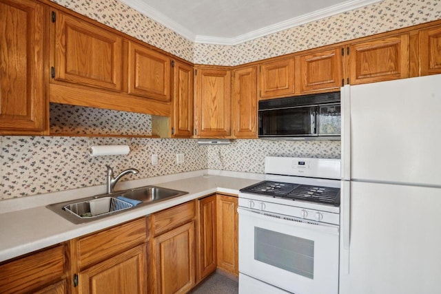 kitchen with white appliances, light countertops, brown cabinets, and a sink