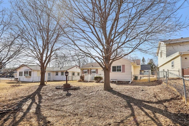 view of yard with a gate, a residential view, a fire pit, and fence