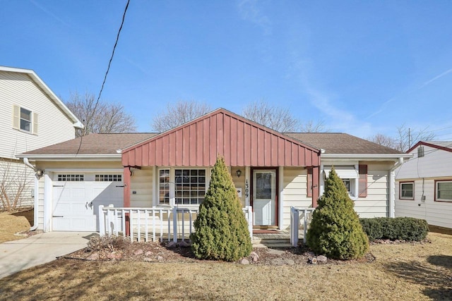 view of front of property with a porch, driveway, a garage, and roof with shingles