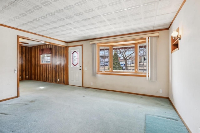 unfurnished room featuring carpet, baseboards, an ornate ceiling, and ornamental molding