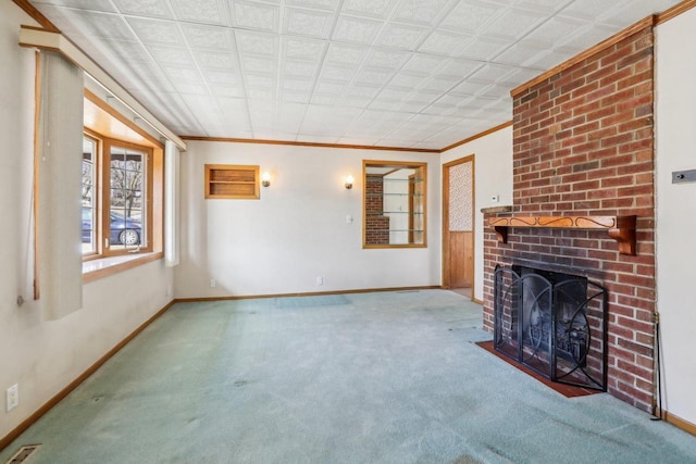 unfurnished living room with visible vents, carpet flooring, a fireplace, crown molding, and baseboards