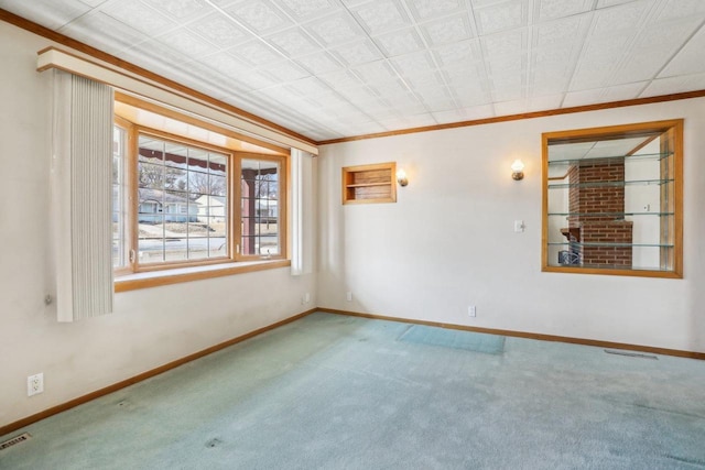 unfurnished room with baseboards, carpet, and crown molding