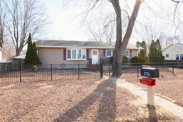 ranch-style home featuring a fenced front yard