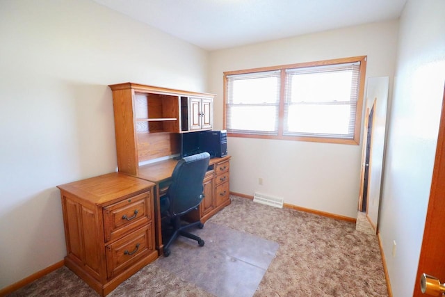 office area featuring visible vents, light colored carpet, and baseboards