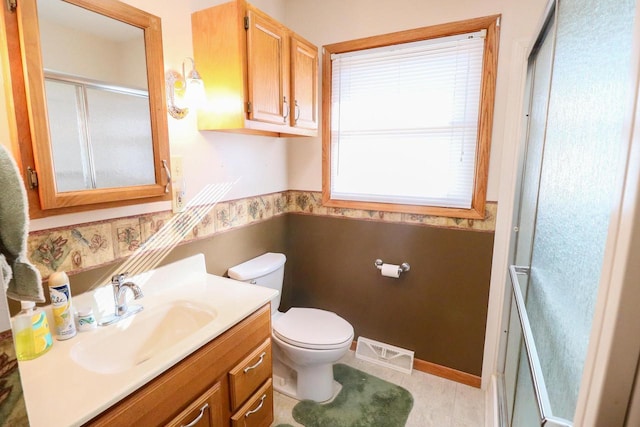 bathroom with visible vents, a wainscoted wall, toilet, a shower stall, and vanity