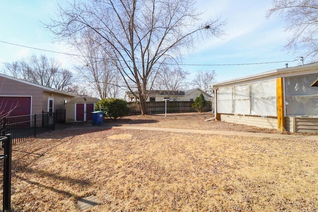 view of yard featuring an outbuilding and fence