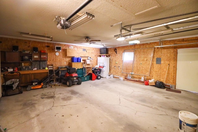 garage featuring a workshop area, a garage door opener, and freestanding refrigerator