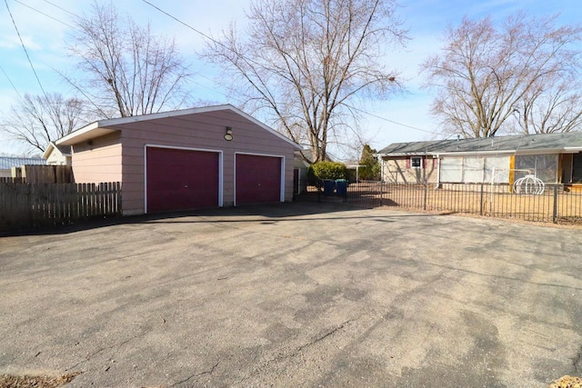 detached garage featuring fence