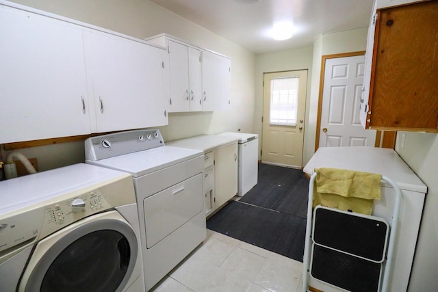 laundry room featuring tile patterned floors, cabinet space, and washer and clothes dryer