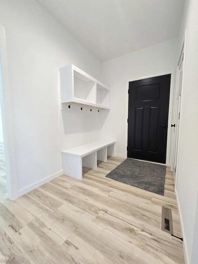 mudroom featuring light wood-style flooring, visible vents, and baseboards