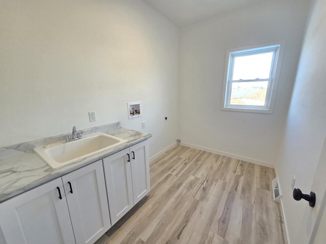 laundry room with electric dryer hookup, a sink, cabinet space, light wood-style floors, and hookup for a washing machine