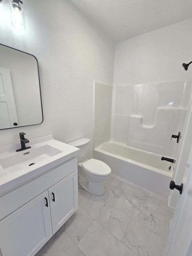 full bathroom with shower / bathing tub combination, toilet, marble finish floor, and vanity