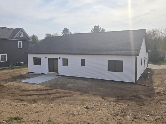 460 Hollander St, Markesan, WI 53946 - back of property with a patio area, central AC unit, and roof with shingles