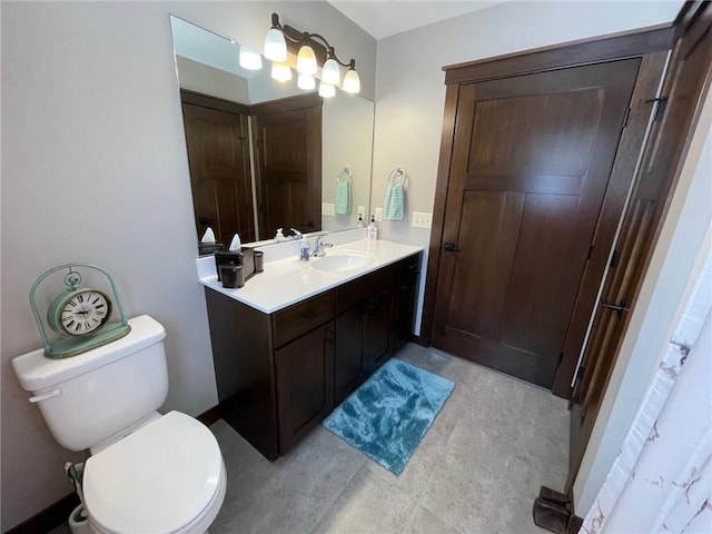 full bathroom with toilet and vanity