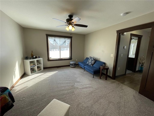 unfurnished room featuring baseboards, a textured ceiling, ceiling fan, and carpet flooring