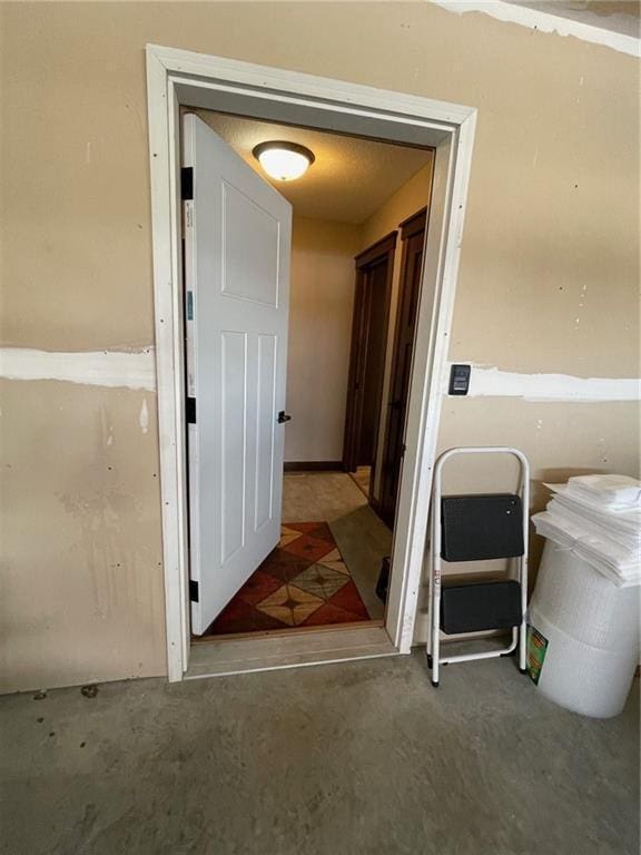 hall with unfinished concrete floors