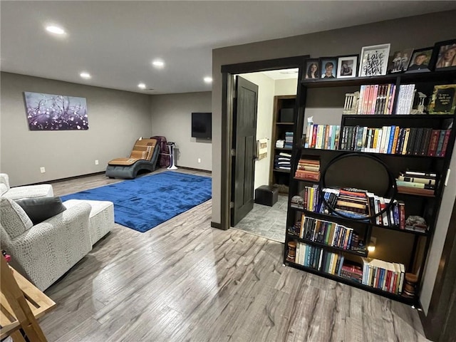 living area with recessed lighting, wood finished floors, and baseboards