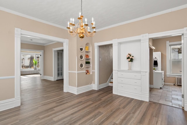 unfurnished dining area with a wealth of natural light, radiator, wood finished floors, and crown molding