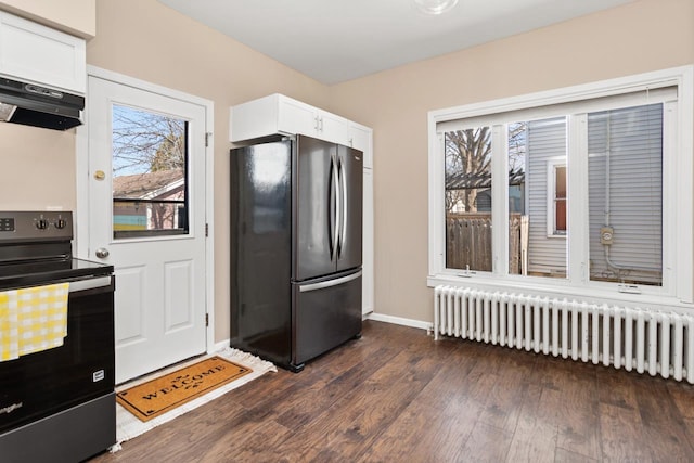 kitchen featuring radiator, appliances with stainless steel finishes, dark wood finished floors, and white cabinetry